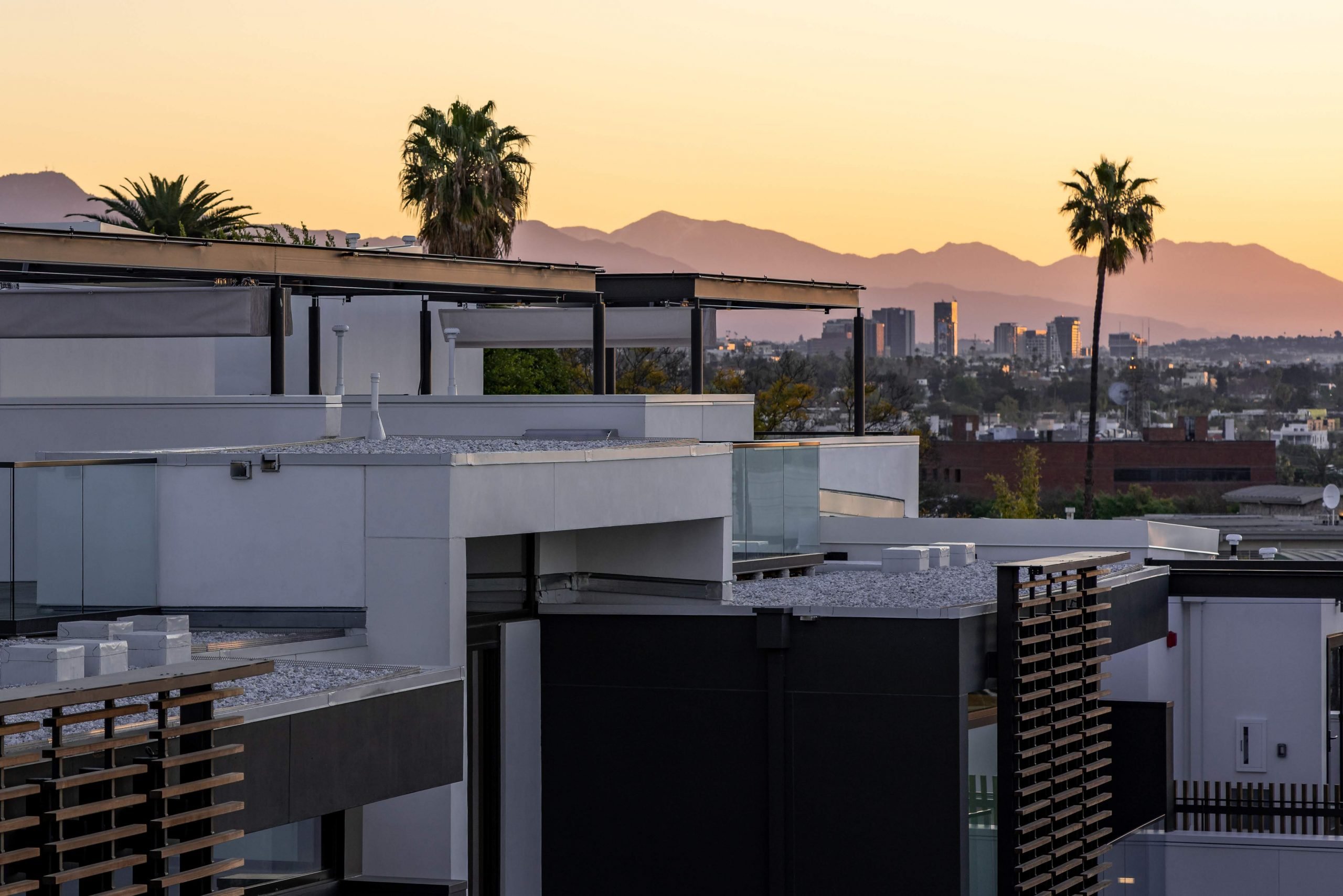 View from the rooftops looking across at the surrounding cityscape at The Harland West Hollywood during a beautiful sunset in West Hollywood California features Kebony Modified Wood Clear Cladding