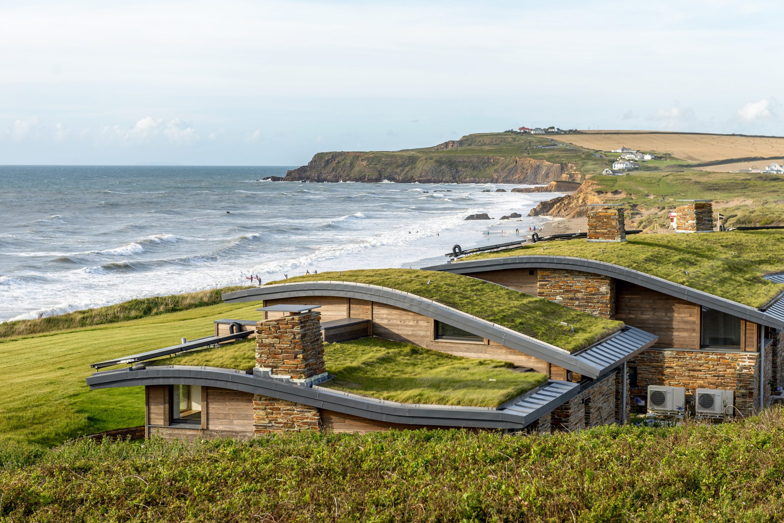 Sunny day looking at the Atlantic View Cottages featuring Kebony Modified Wood Clear Cladding located on Widemouth Bay, Bude, United Kingdom