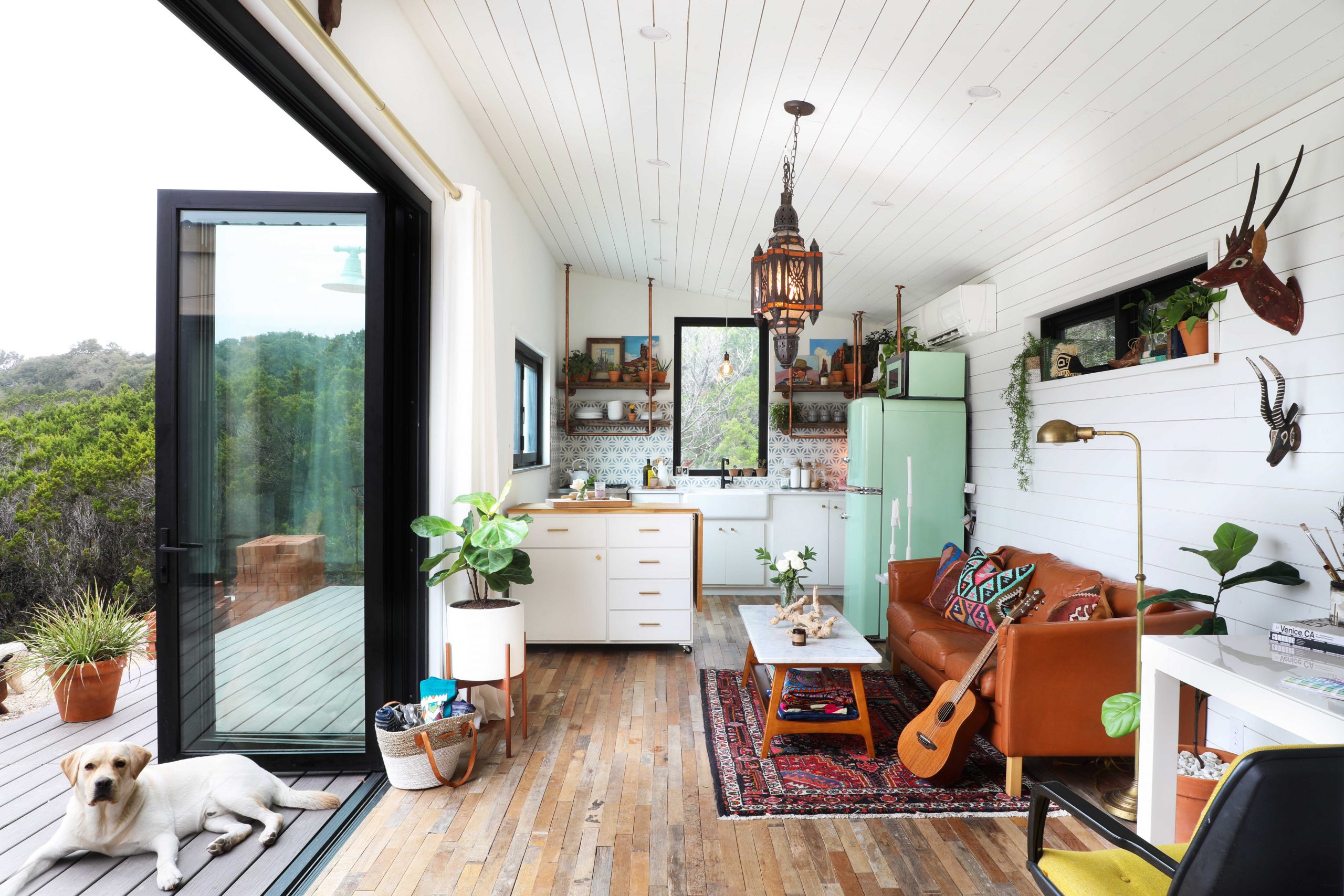 Interior side view of the study and kitchen area at the Peached Casita Tiny House featuring Kebony Modified Wood Clear Decking located near Dripping Springs, Texas