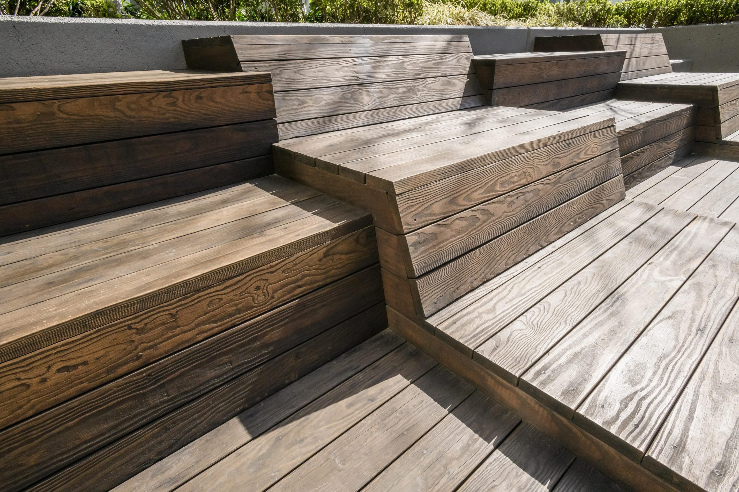 The seating areas and benches in this outdoor retail plaza feature Kebony Modified Wood Clear decking and is located at the 303 Second Street property
