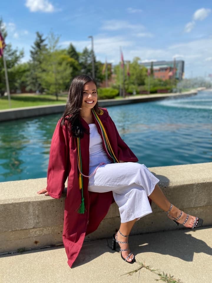 Portrait of Haley Bacarella, a Kebony Modified Wood Business Development Specialist, in her graduation gown on a sunny day