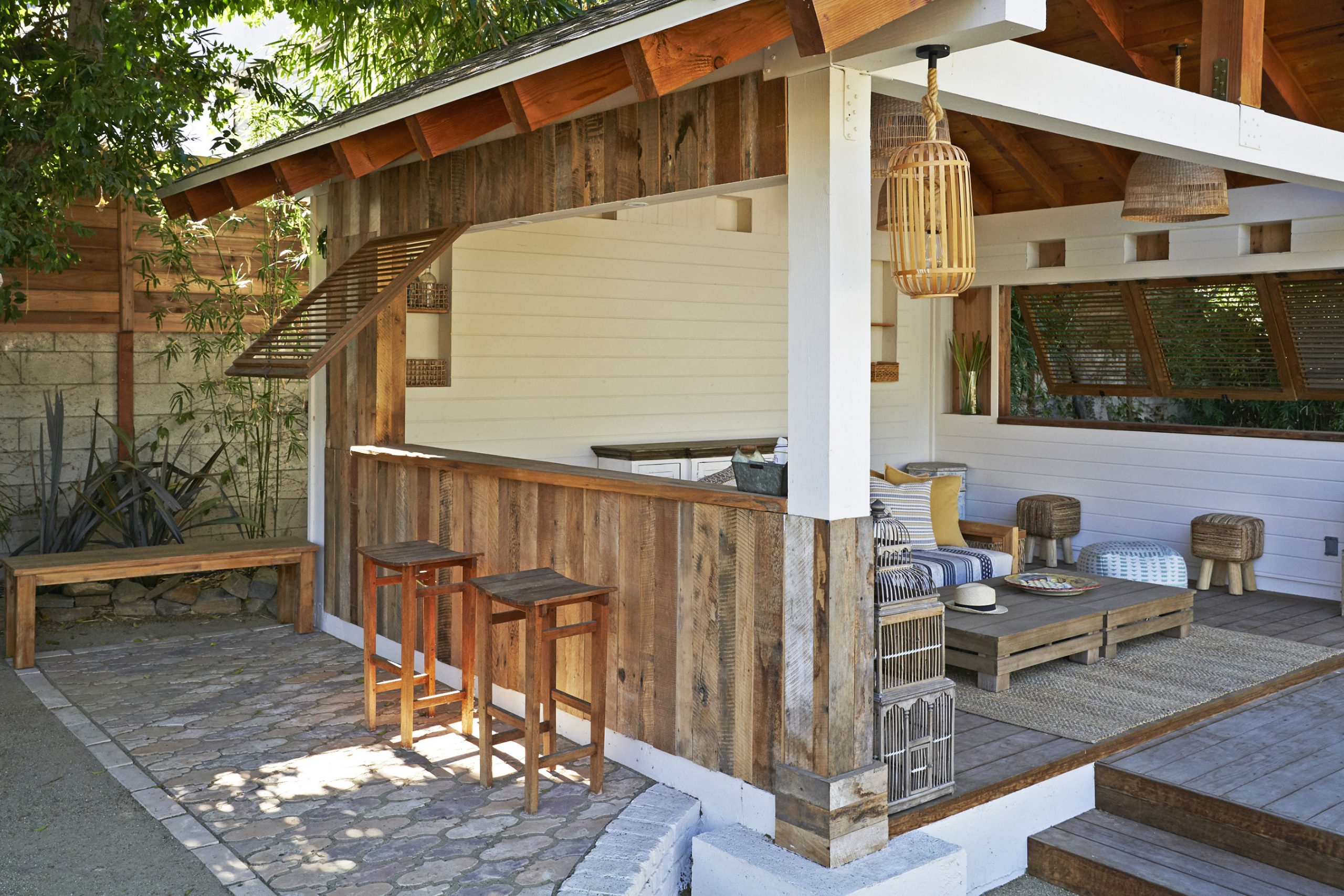 Pool house bar with two stools of the Rum Punch House in Los Angeles California featuring Kebony Modified Wood Clear Decking during the day