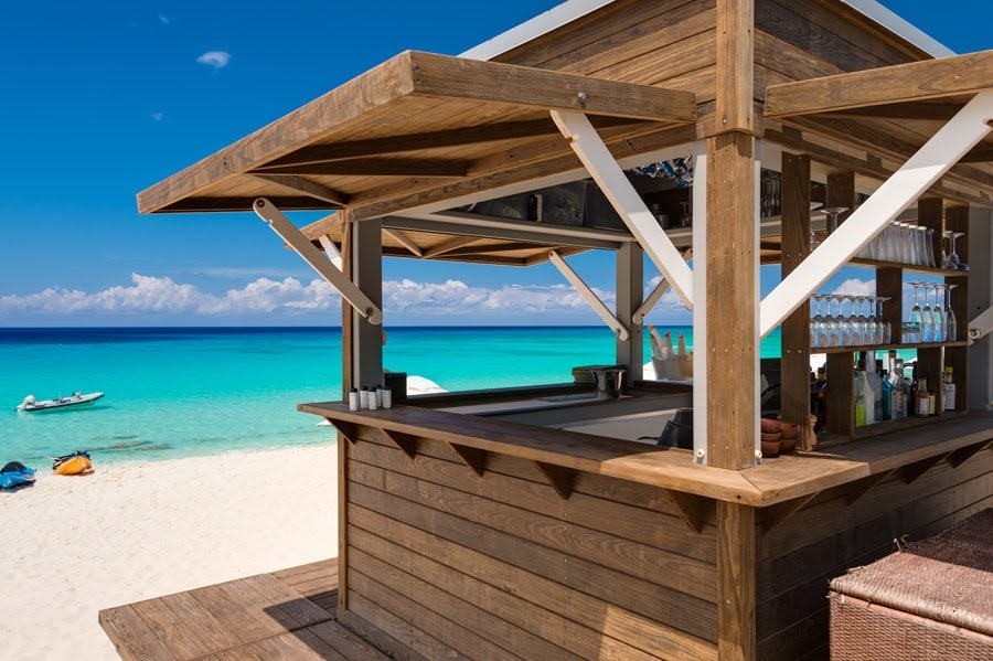 Side view of the Amanyara Resort Beach Hut in Turks & Caicos featuring Kebony Modified Wood Clear Cladding during the day with the beautiful blue ocean in the background