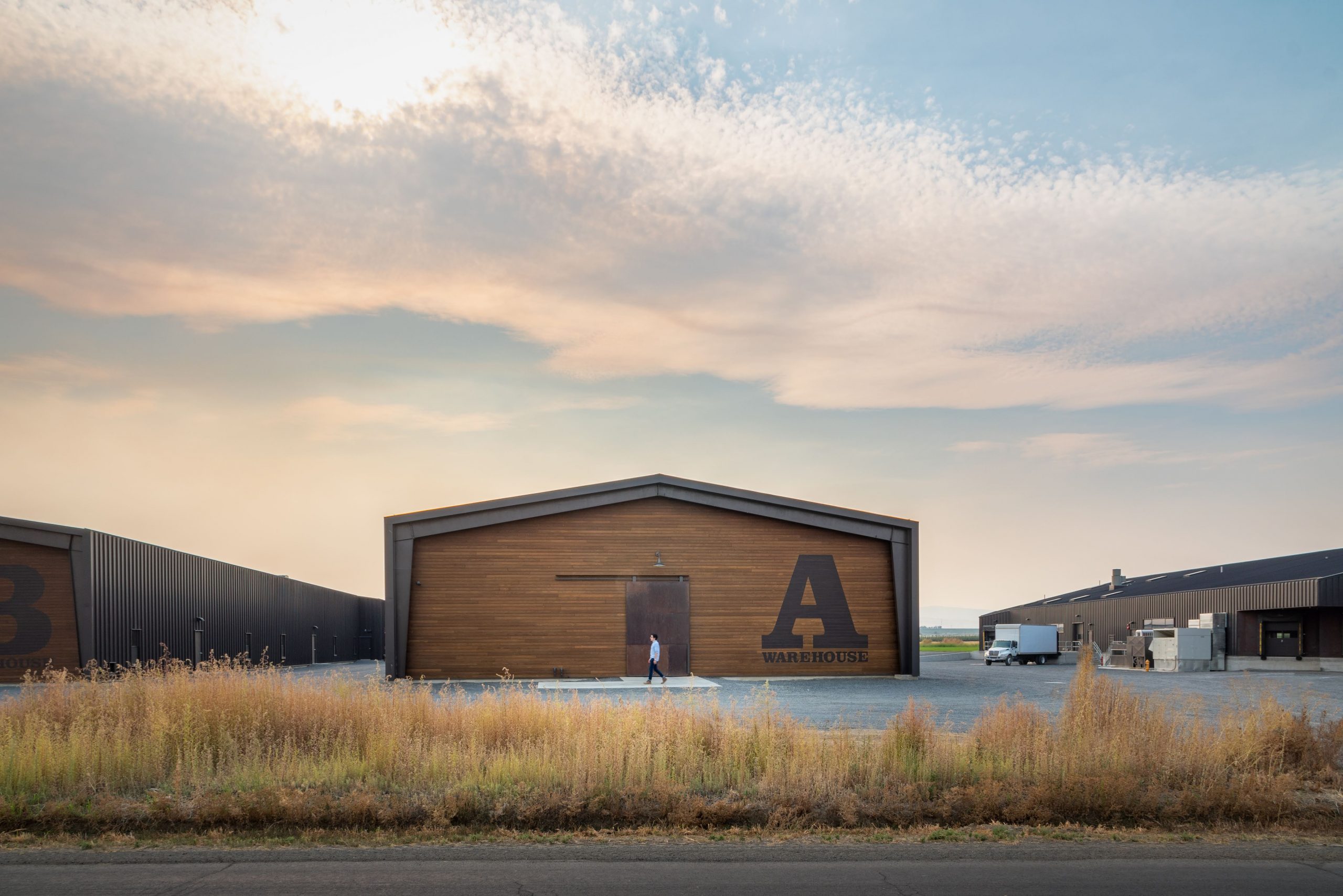 View of the Woodinville Whiskey Company warehouses in Woodinville Washington during sunset featuring kebony modified wood siding and passive rainscreen cladding