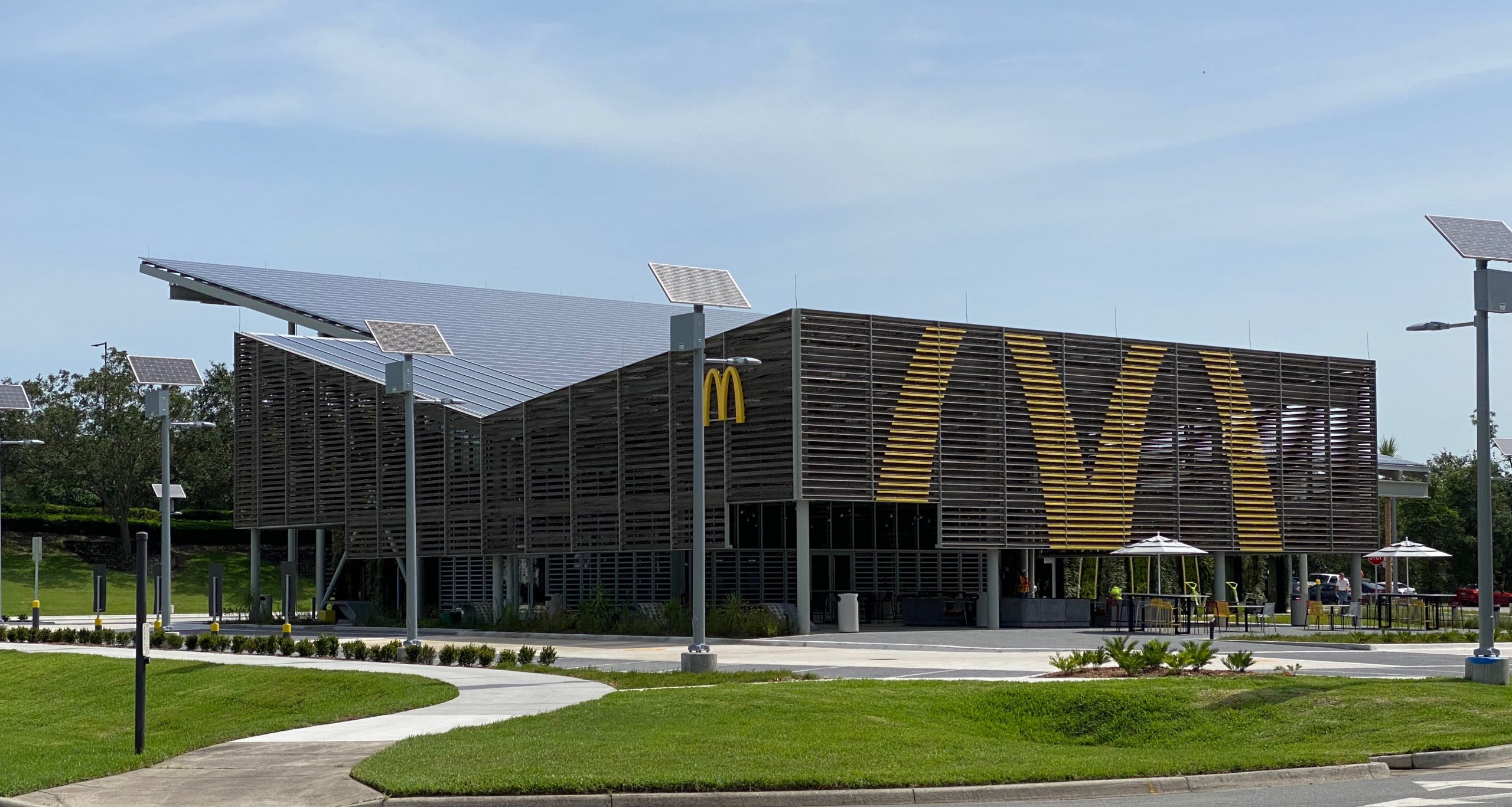 The McDonald's at the Walt Disney World resort in Bay Lake Florida during the day featuring kebony modified wood siding showcasing the McDonald's golden arch logo painted on the side of the building