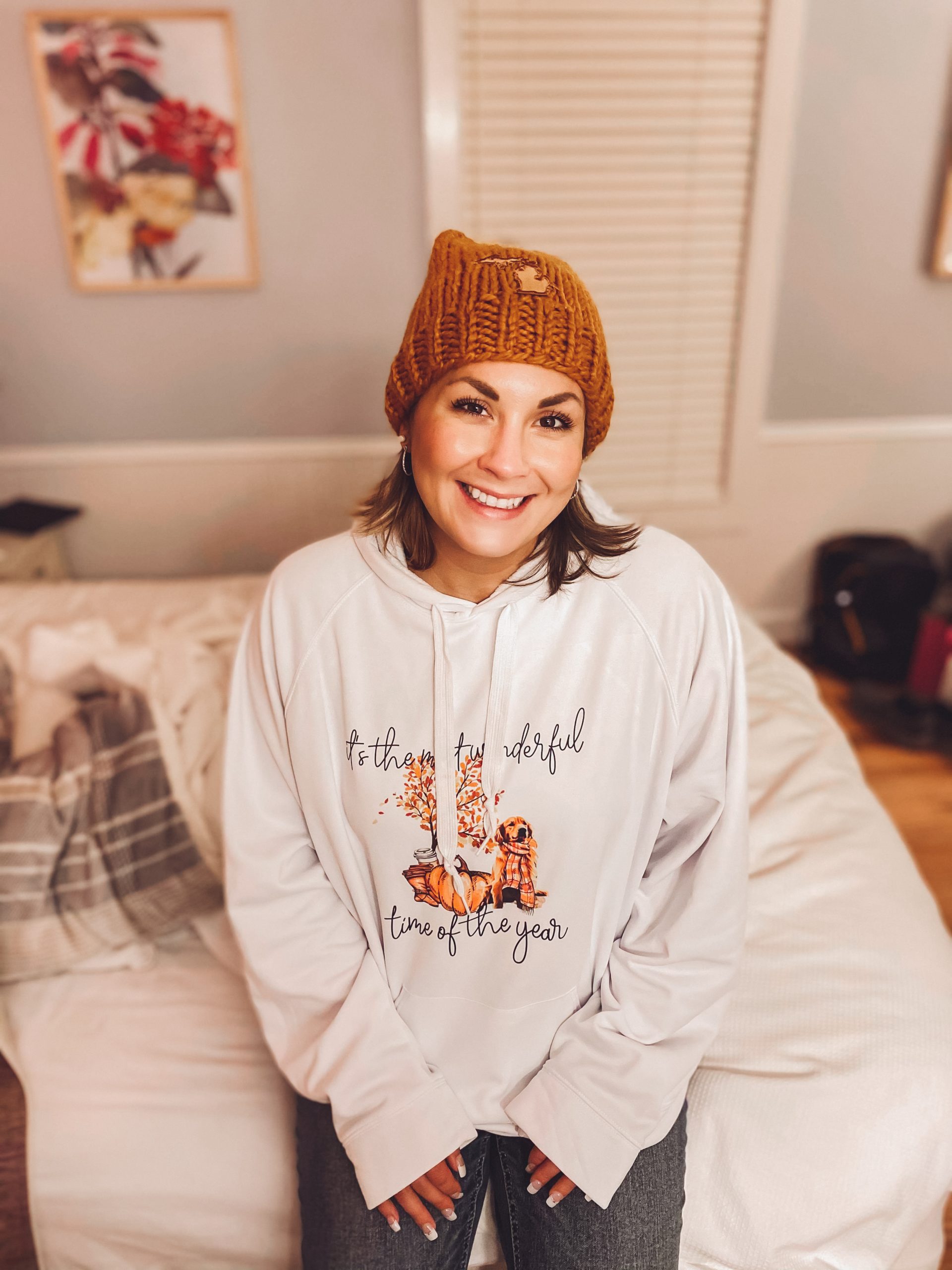 Portrait of Kelsey Thibert smiling in a cozy room