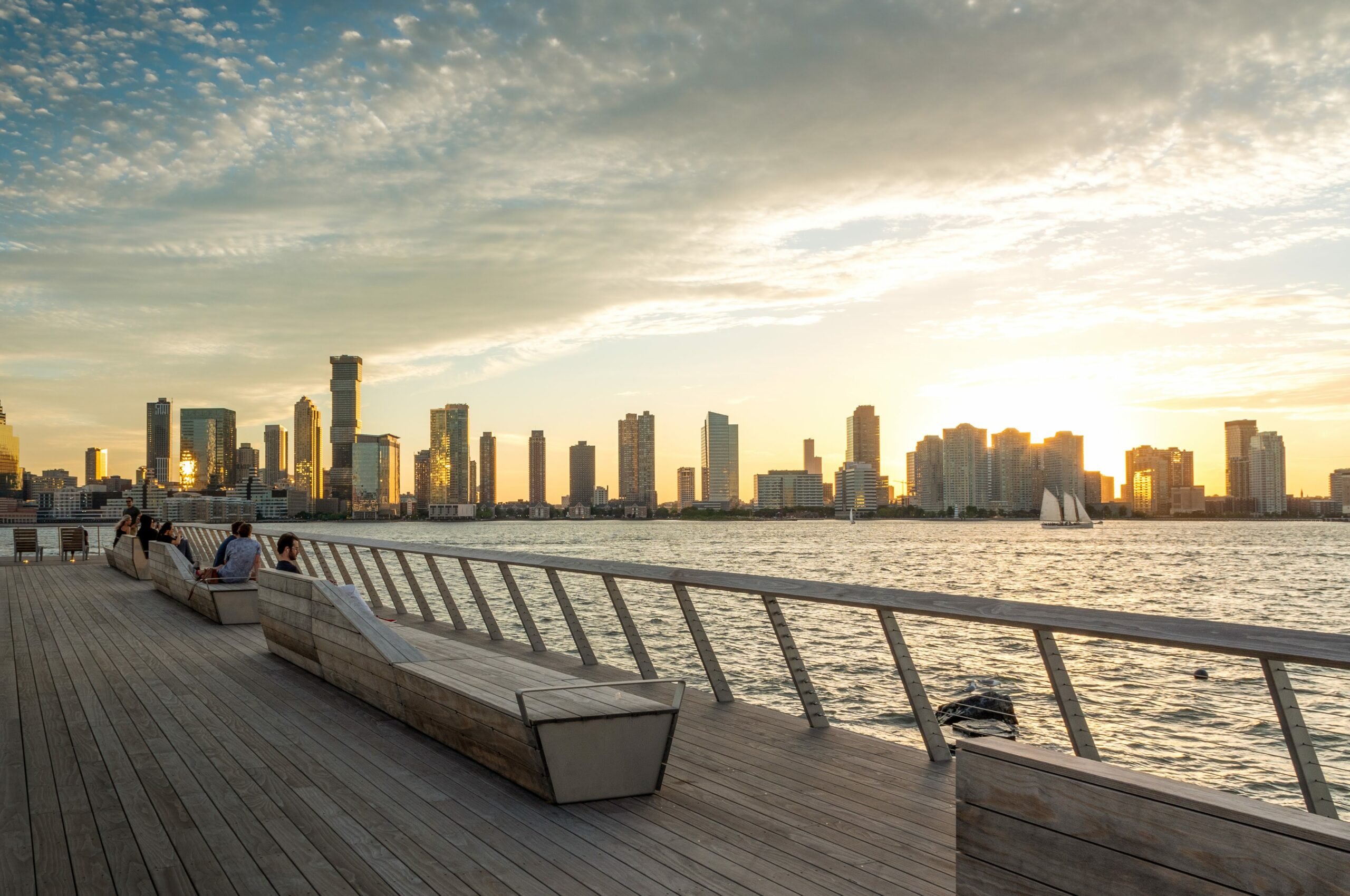 Kebony modified wood Clear Boardwalk Decking city overlook lounge area with reclining seats at Pier 26 during sunset at the Hudson River Park in New York City New York