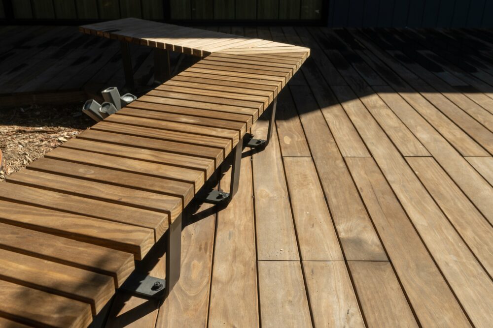The sun shines on the Kebony modified wood deck and bench at sportsman's lodge California