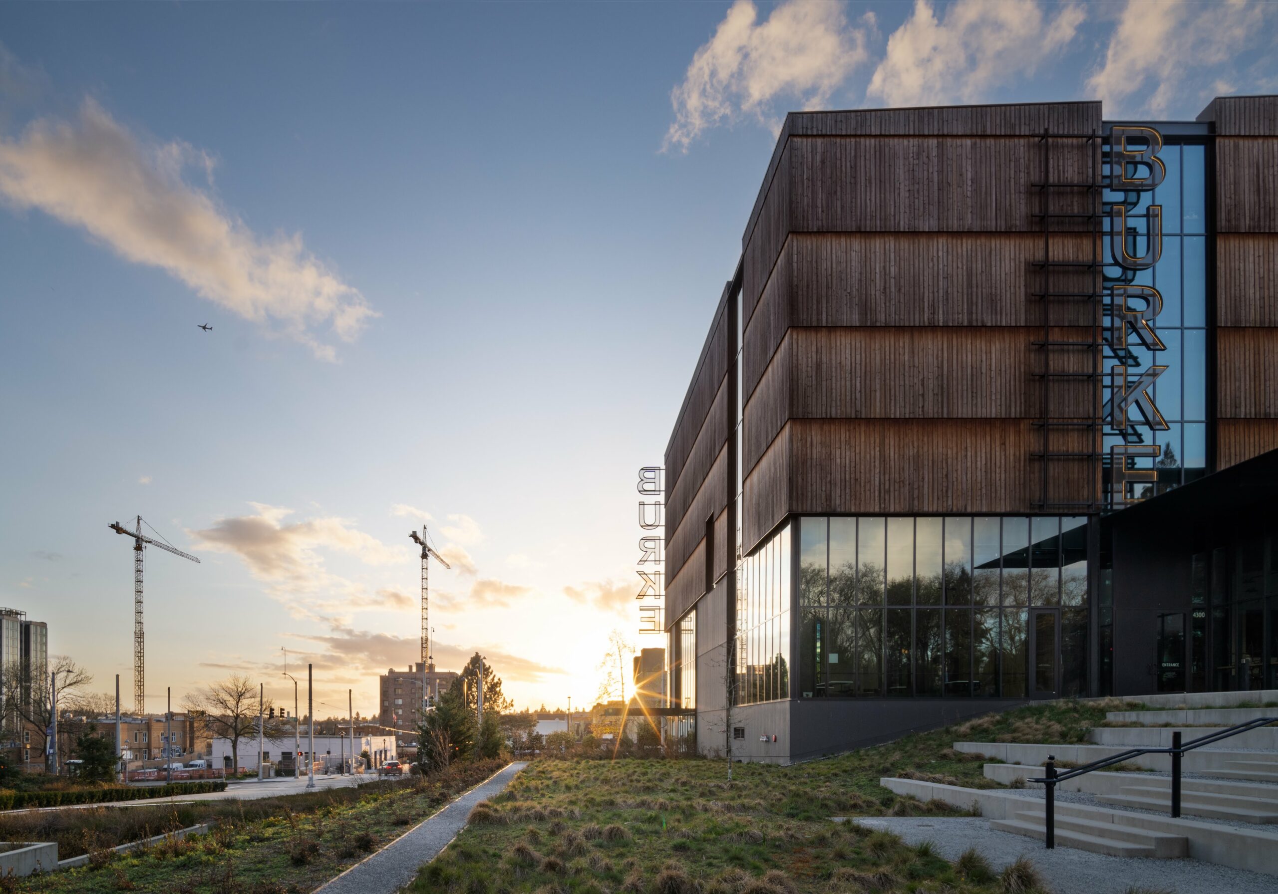 Exterior view of the burke natural history museum during a sunrise featuring kebony modified wood click in cladding